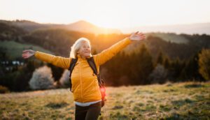 Front,View,Of,Senior,Woman,Hiker,Standing,Outdoors,In,Nature