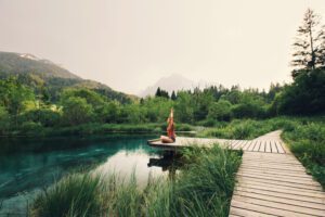 Young,Woman,Doing,Yoga,And,Meditating,In,Lotus,Position,On